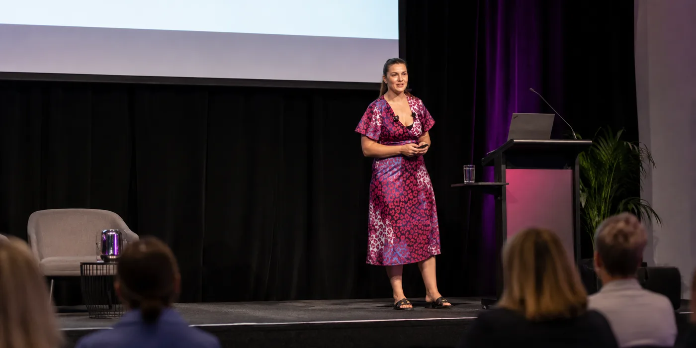 Jitka Lopez speaking on stage at a First Light workshop